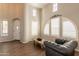 Bright and airy living room with high ceilings, arched windows, and modern minimalist decor at 18283 N 93Rd St, Scottsdale, AZ 85255