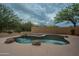 Private backyard with a pool surrounded by rock accents, a wood deck and privacy landscaping creating a relaxing oasis at 18283 N 93Rd St, Scottsdale, AZ 85255