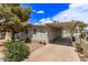 Well-maintained home with a covered parking area and appealing landscaping under a partly cloudy sky at 201 S Greenfield Rd # 331, Mesa, AZ 85206