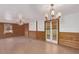 Inviting living room featuring a chandelier, tiled floors, and unique paneled walls at 201 S Greenfield Rd # 331, Mesa, AZ 85206