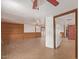 Spacious open-plan living space featuring tile flooring, a large refrigerator, and unique paneled walls at 201 S Greenfield Rd # 331, Mesa, AZ 85206