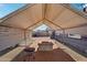 Covered backyard patio with brick flooring and a cinder block fire pit at 2118 E Oak St, Phoenix, AZ 85006