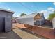 Backyard patio with a metal awning, a red brick base, and low-maintenance gravel at 2118 E Oak St, Phoenix, AZ 85006