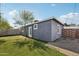 View of the side yard and backyard featuring artificial turf and a well-maintained exterior at 2118 E Oak St, Phoenix, AZ 85006