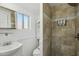 Bathroom showcases tiled shower, vanity with mirror, and a window at 2118 E Oak St, Phoenix, AZ 85006