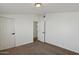 The bedroom features neutral carpet, white walls and two closet doors at 2118 E Oak St, Phoenix, AZ 85006