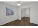 Bright bedroom with a window, ceiling fan, wood-look floors and closet with mirrored sliding doors at 2118 E Oak St, Phoenix, AZ 85006