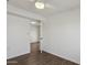 Bright bedroom with a ceiling fan, wood-look floors and an open doorway to another room at 2118 E Oak St, Phoenix, AZ 85006