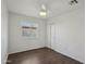 Bright bedroom with a window, ceiling fan, wood-look floors and sliding door closet at 2118 E Oak St, Phoenix, AZ 85006