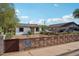 Charming single-story home featuring a well-kept yard with lovely brick wall and quaint curb appeal at 2118 E Oak St, Phoenix, AZ 85006