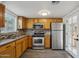 Efficient kitchen features stainless steel appliances, tile backsplash, wood cabinets and an adjacent dining area at 2118 E Oak St, Phoenix, AZ 85006