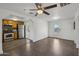Open-concept living room features light walls, new flooring, contemporary ceiling fan, and an open kitchen concept at 2118 E Oak St, Phoenix, AZ 85006