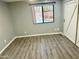 Bedroom featuring wood-look floors, view to the pool, and a barn door closet at 2138 E Williams Dr, Phoenix, AZ 85024