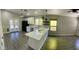 Modern kitchen featuring an island cooktop, an eat-in bar, recessed lights, and gray-tone floors at 2138 E Williams Dr, Phoenix, AZ 85024