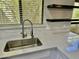 Modern kitchen sink with sleek fixtures, quartz countertop, and window views at 2138 E Williams Dr, Phoenix, AZ 85024