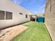Backyard featuring artificial grass, sand, and a covered patio at 2300 E Magma Rd # 74, San Tan Valley, AZ 85143