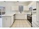 Bright kitchen featuring white cabinets, modern stainless steel appliances, and quartz countertops at 2300 E Magma Rd # 74, San Tan Valley, AZ 85143
