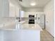 Bright kitchen featuring white cabinets, modern appliances, and light countertops with a breakfast bar at 2300 E Magma Rd # 74, San Tan Valley, AZ 85143