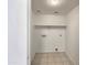 A simple laundry room with tile floor and a shelf at 2300 E Magma Rd # 74, San Tan Valley, AZ 85143