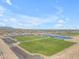 High aerial of lush sports fields, with lake, playground and shade ramadas in a Primary-planned community at 23693 W Grove St, Buckeye, AZ 85326