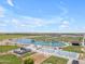 Community park aerial view, featuring a lake, splash pad, and basketball courts at 23693 W Grove St, Buckeye, AZ 85326