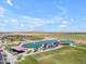Aerial shot of community park amenities including a lake, ball fields, ramadas and parking areas at 23693 W Grove St, Buckeye, AZ 85326