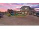 Backyard featuring a playground with slides and a covered patio, creating an ideal outdoor living space at 23693 W Grove St, Buckeye, AZ 85326