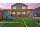 Backyard featuring a playground with slides and a covered patio, creating an ideal outdoor living space at 23693 W Grove St, Buckeye, AZ 85326
