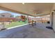 Covered patio with a play structure, table, and swing, perfect for outdoor enjoyment at 23693 W Grove St, Buckeye, AZ 85326