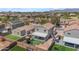 Aerial shot of home's backyard, featuring a playset, covered patio and artificial turf at 23693 W Grove St, Buckeye, AZ 85326
