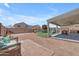 An inviting backyard with a covered patio, playground, and ample space for outdoor activities at 23693 W Grove St, Buckeye, AZ 85326