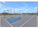 Well-maintained basketball court with lighting, surrounded by green space and park amenities at 23693 W Grove St, Buckeye, AZ 85326