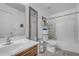 Well-lit bathroom features a sink, toilet, and shower-tub combo with patterned shower curtain at 23693 W Grove St, Buckeye, AZ 85326