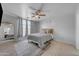 Cozy bedroom with light gray walls, ceiling fan, and comfortable furnishings at 23693 W Grove St, Buckeye, AZ 85326