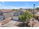 A beautiful two-story home with a well-maintained lawn and a charming front yard tree at 23693 W Grove St, Buckeye, AZ 85326