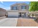 Charming two-story home featuring a spacious driveway and inviting front porch at 23693 W Grove St, Buckeye, AZ 85326