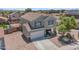 Aerial view of a well-maintained two-story home with tile roof and desert landscaping at 23693 W Grove St, Buckeye, AZ 85326