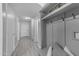 Hallway with light gray wood-look floors and gray walls with storage and hooks at 23693 W Grove St, Buckeye, AZ 85326