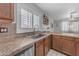 The kitchen features a stainless steel sink, brown countertops, and white shutters at 23693 W Grove St, Buckeye, AZ 85326