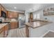Well-lit kitchen with stainless steel appliances, wood cabinets, and breakfast bar at 23693 W Grove St, Buckeye, AZ 85326