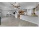 Open concept living space with tile floors connecting the kitchen and living area at 23693 W Grove St, Buckeye, AZ 85326