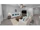 Bright living room features stylish furniture, decor and plenty of seating at 23693 W Grove St, Buckeye, AZ 85326