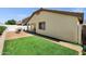 Backyard with artificial turf, a covered patio, and low-maintenance landscaping at 23862 W Chambers St, Buckeye, AZ 85326
