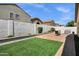 Well-maintained backyard with artificial turf, privacy walls, and a brick patio for outdoor relaxation and enjoyment at 23862 W Chambers St, Buckeye, AZ 85326