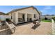 Charming backyard features a covered patio with seating and a paved area, perfect for outdoor entertaining at 23862 W Chambers St, Buckeye, AZ 85326