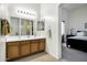 Bathroom featuring a double sink vanity with wood cabinets and a large mirror at 23862 W Chambers St, Buckeye, AZ 85326