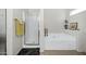 Bright bathroom featuring a glass-enclosed shower, bathtub and decorative accents at 23862 W Chambers St, Buckeye, AZ 85326