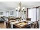 An elegantly furnished dining room boasts a chandelier and a view of the living area at 23862 W Chambers St, Buckeye, AZ 85326