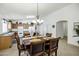A formal dining room features a stylish chandelier and adjacent kitchen space at 23862 W Chambers St, Buckeye, AZ 85326