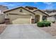 Beautifully landscaped single-story home featuring a neutral color palette and attached two-car garage at 23862 W Chambers St, Buckeye, AZ 85326